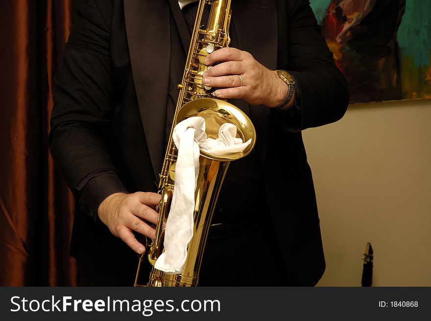 Musicians hands playing his saxophone in restaurant. Musicians hands playing his saxophone in restaurant