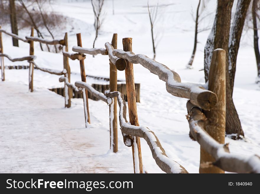 Wooden fence, sidewalk and couple of trees with fresh snow. Wooden fence, sidewalk and couple of trees with fresh snow