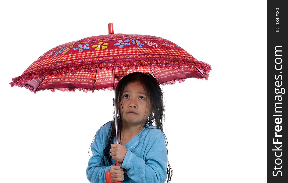 A young girl is wet, cold and scared under an umbrella. A young girl is wet, cold and scared under an umbrella