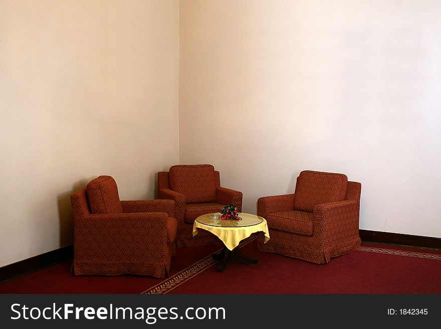 Comfortable place - armchairs in the corner with small table in front cover with yellow. Comfortable place - armchairs in the corner with small table in front cover with yellow