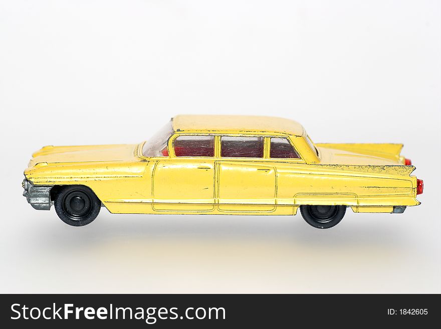 Old Abused Yellow Toy Cadillac Sideview