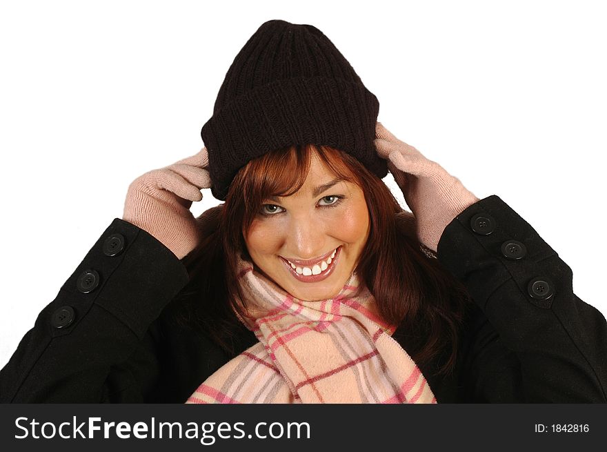 Smiling brunette wearing a winter hat, gloves, scarf and jacket isolated against a white background. Smiling brunette wearing a winter hat, gloves, scarf and jacket isolated against a white background.