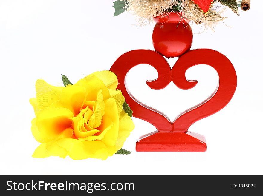 Yellow man made flower and heart shape candlestick isolated on white