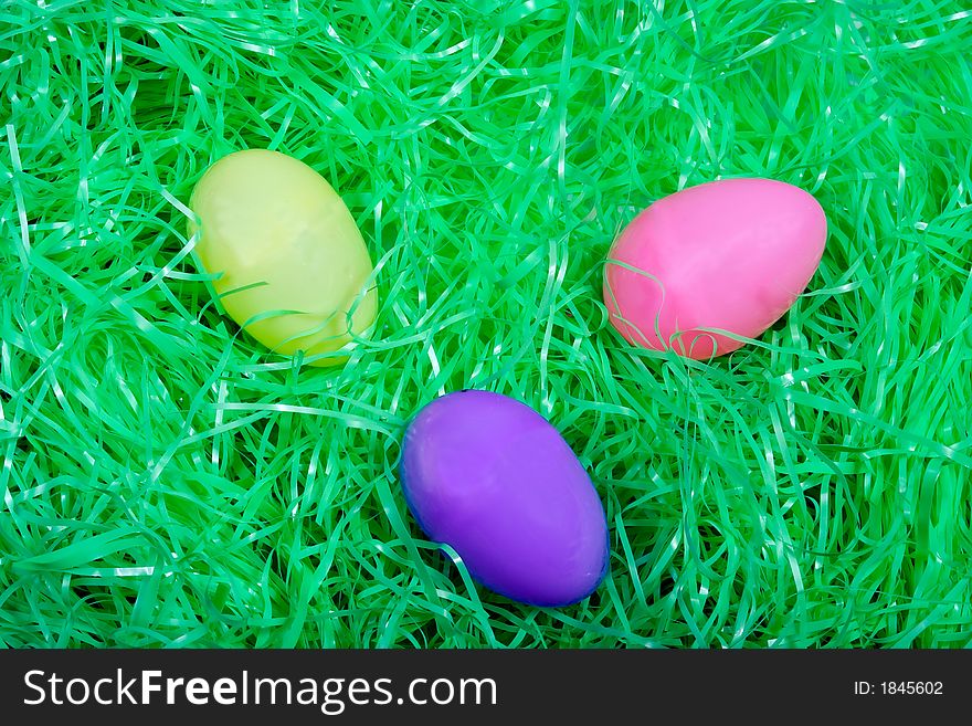 Colored Easter eggs on bed of easter grass. Colored Easter eggs on bed of easter grass