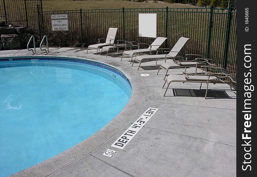 Outside swimming pool with chairs