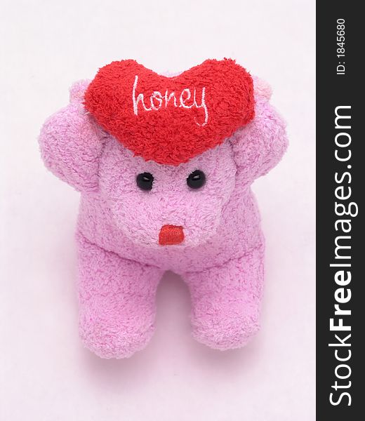 Stuffed valentine's bear holding heart that says honey. Stuffed valentine's bear holding heart that says honey