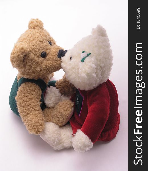 Stuffed male and female valentine's bears kissing. Stuffed male and female valentine's bears kissing