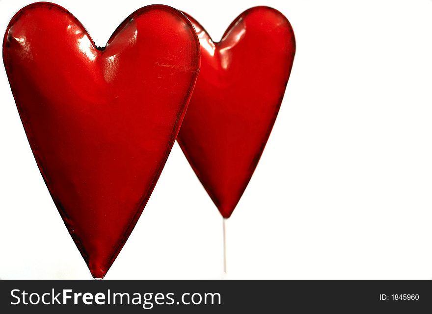 Two  tin-hearts in red,  on white background. Two  tin-hearts in red,  on white background