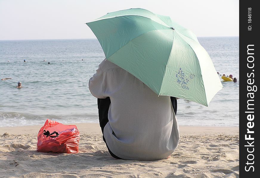 Local watching the tourists in the sea