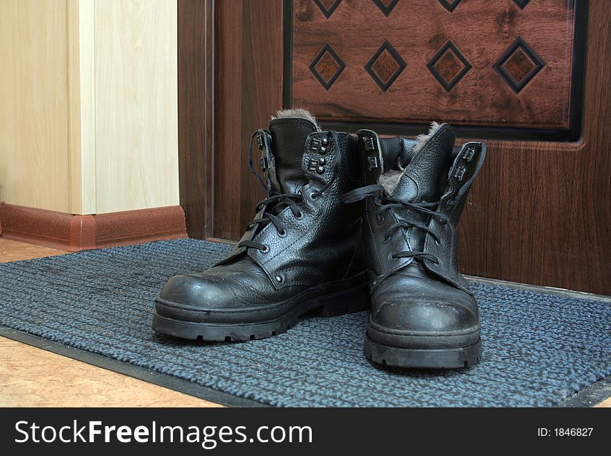 Man's boots near the door