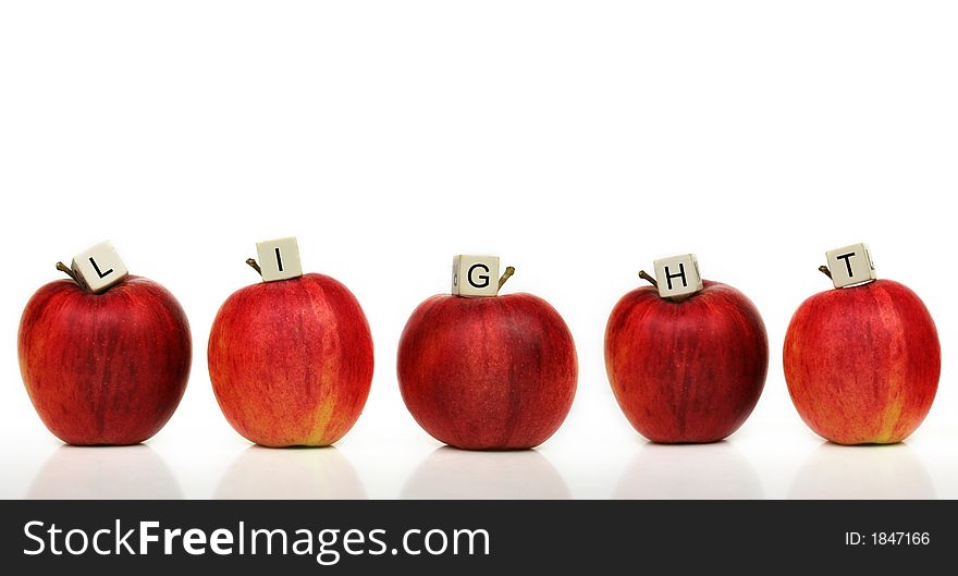 Red apple and cubes with letters in front of a white background - light. Red apple and cubes with letters in front of a white background - light