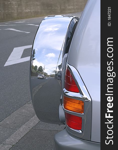 Image of a car on a road reflected in a side wheel of a Jeep-interesting image which can be used in your designs to suggest ideas such as travels, holidays, vacations. Image of a car on a road reflected in a side wheel of a Jeep-interesting image which can be used in your designs to suggest ideas such as travels, holidays, vacations.
