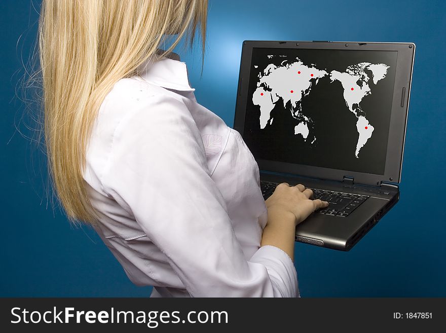 Woman is holding laptop with world map on the screen. Woman is holding laptop with world map on the screen.