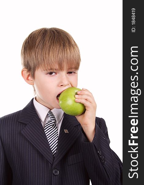 A young boy with his apple, against white background.