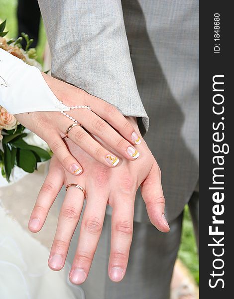 Hands of the groom and the bride with wedding rings. Hands of the groom and the bride with wedding rings