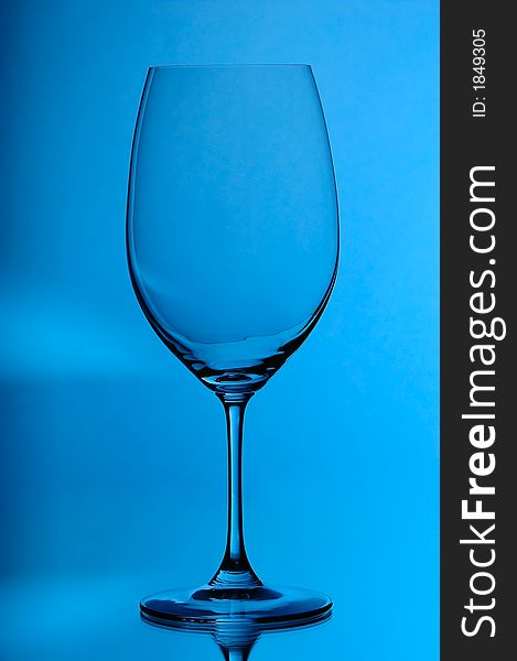 Bordeaux rouge wineglass, on blue background. Bordeaux rouge wineglass, on blue background