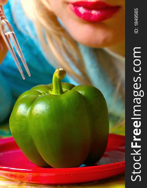 Green pepper on the red plate, eaten by girl