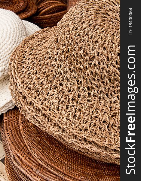 A straw woven hat on sale at a handicraft store. A straw woven hat on sale at a handicraft store