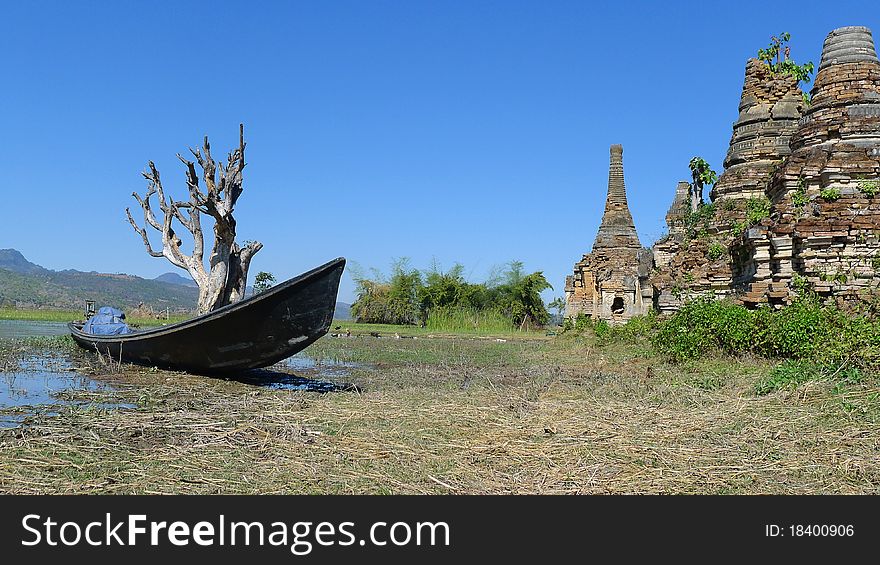 Landscape of a group of ancient buddhist stupa with a boat and dead tree in Myanmar. Landscape of a group of ancient buddhist stupa with a boat and dead tree in Myanmar