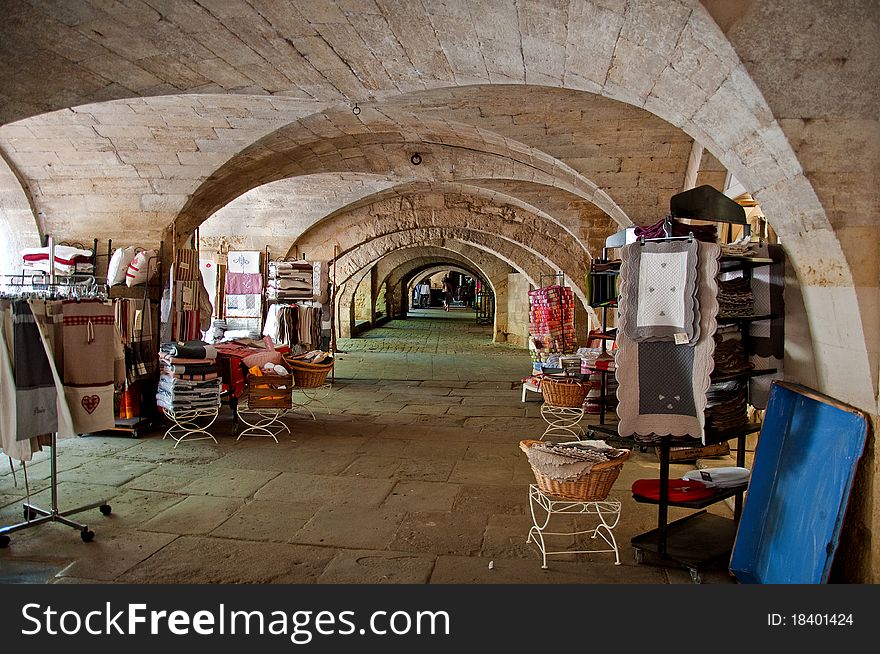 An ancient arcade is used for display goods on the counter