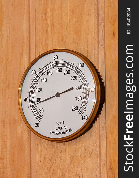 Sauna thermometer display with wooden background