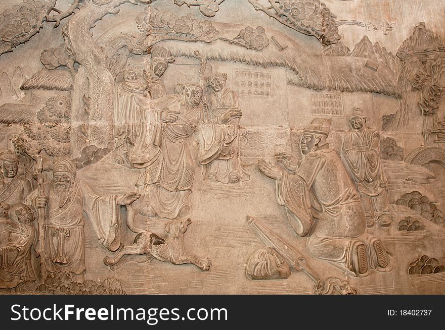 An ancient stone carving in a Buddhist temple telling a story of Buddhism