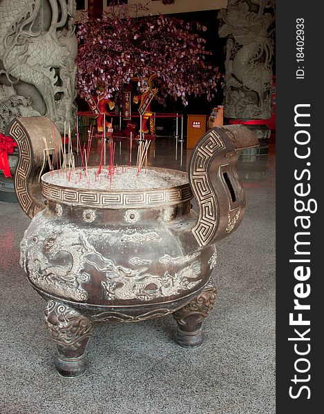 Incense burning in front of a Buddhist temple. Incense burning in front of a Buddhist temple