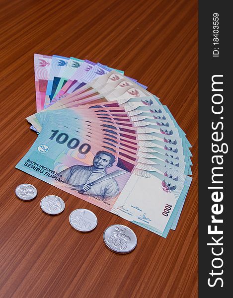 An abstract of colorful bank notes and coins of Indonesian currency. An abstract of colorful bank notes and coins of Indonesian currency