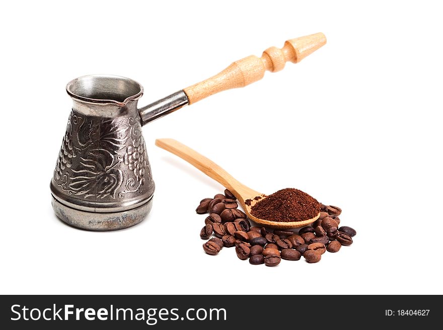 Old coffee pot and coffee beans isolated on white. Old coffee pot and coffee beans isolated on white.