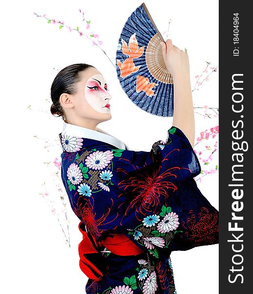 Japan geisha woman with creative make-up dancing with fan