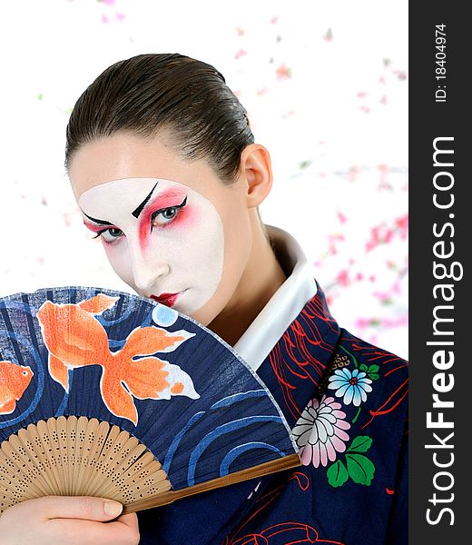 Japan geisha woman with creative make-up with fan