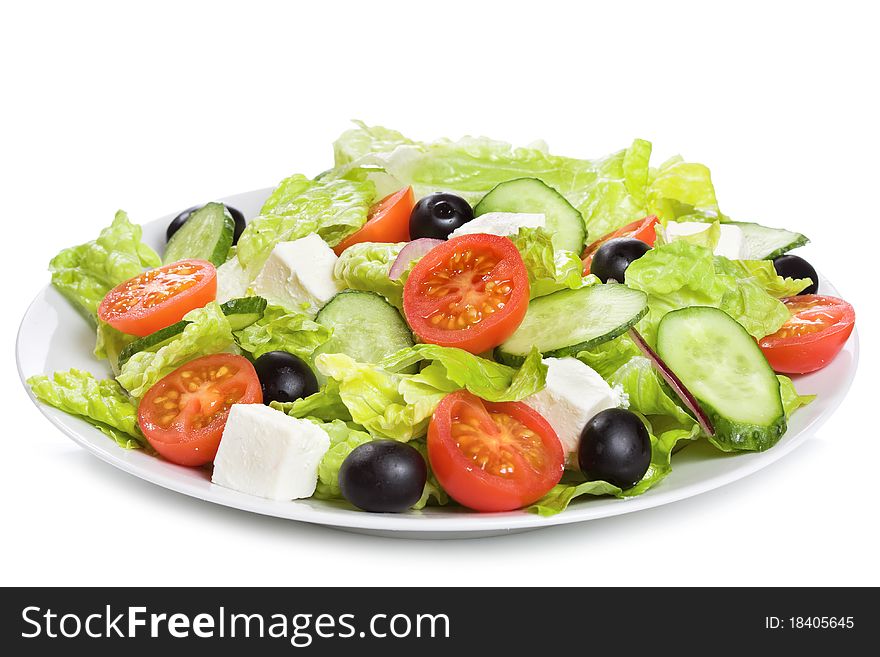 Salad with vegetables and greens on white background