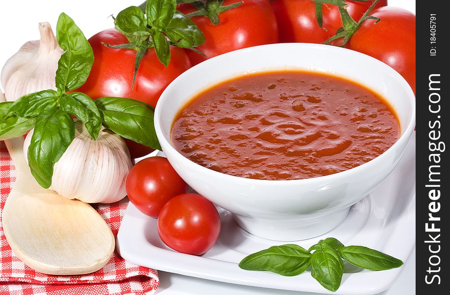 Tomato soup with basil leaves and vegetables