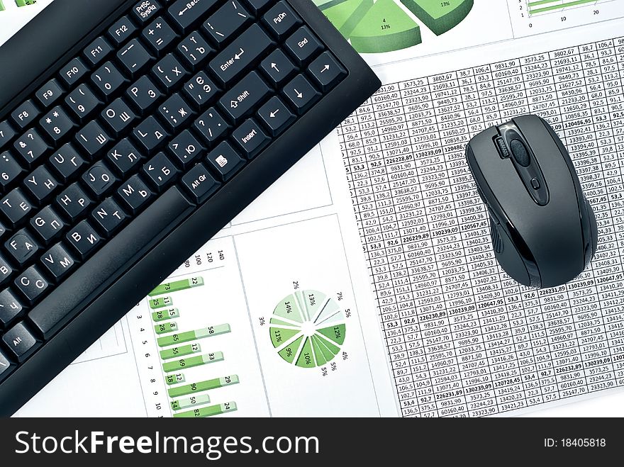 Black keyboard and mouse on a stock chart. Black keyboard and mouse on a stock chart.