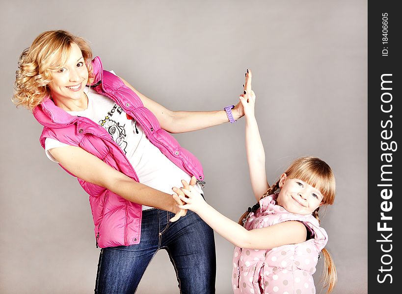 Two girls holding hands and smiling in studio