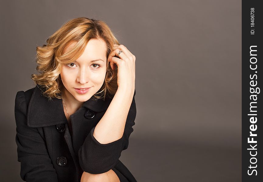 Blond Girl In A Black Jacket, Gray Background