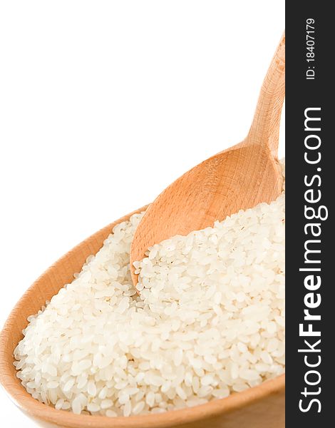 Rice grain in wooden spoon isolated on white