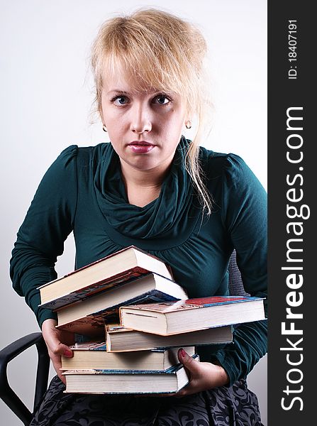 girl holds the pile of books. girl holds the pile of books