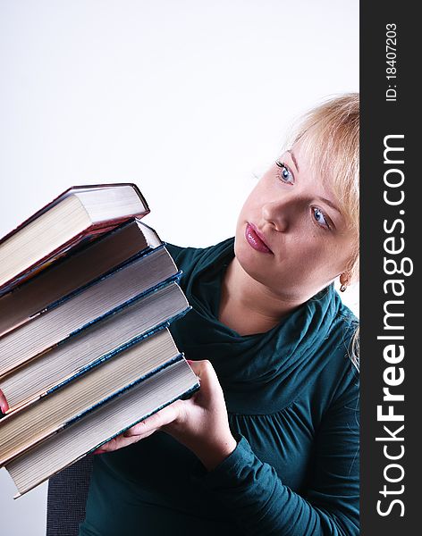 girl holds the pile of books on white