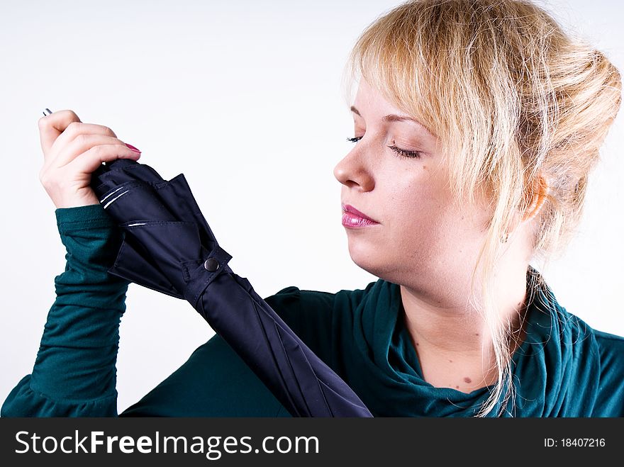 Portrait of pretty blond girl with umbrella