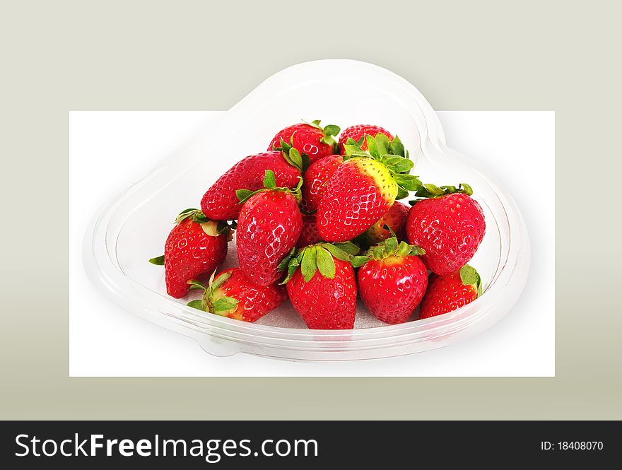 Strawberries in the transparent plate isolated on the white-gray surface with clipping paths. Strawberries in the transparent plate isolated on the white-gray surface with clipping paths.