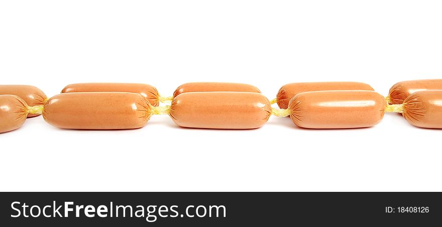 Line of appetizing sausages on the white surface. Line of appetizing sausages on the white surface.