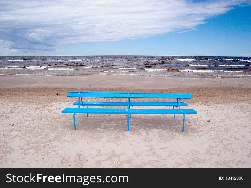 Blue bench on the beach