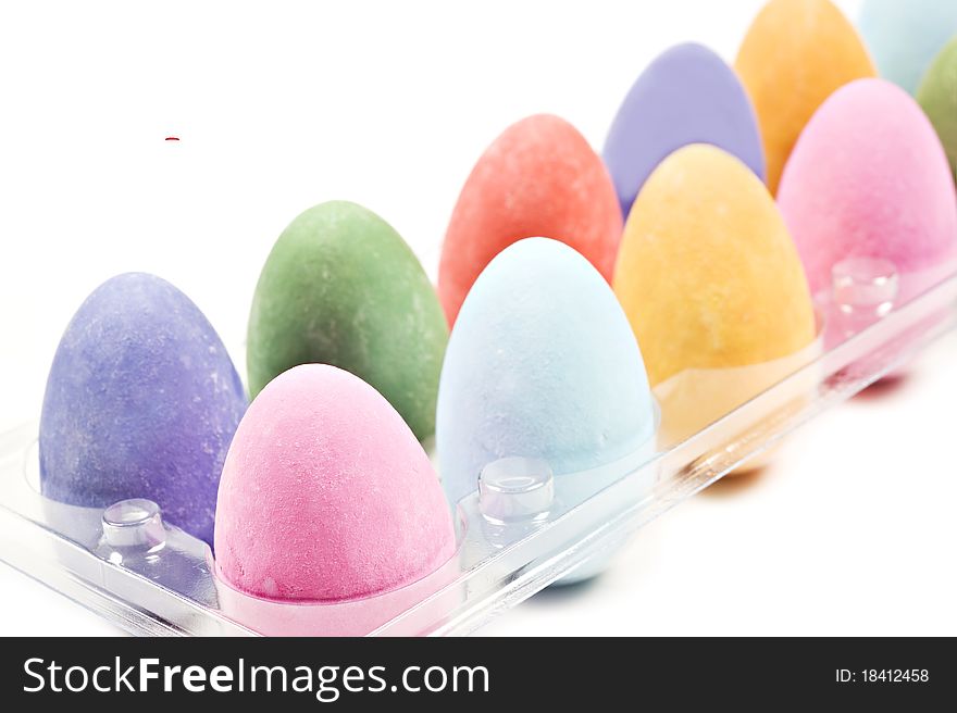 Colorful easter eggs in a tray on a white background