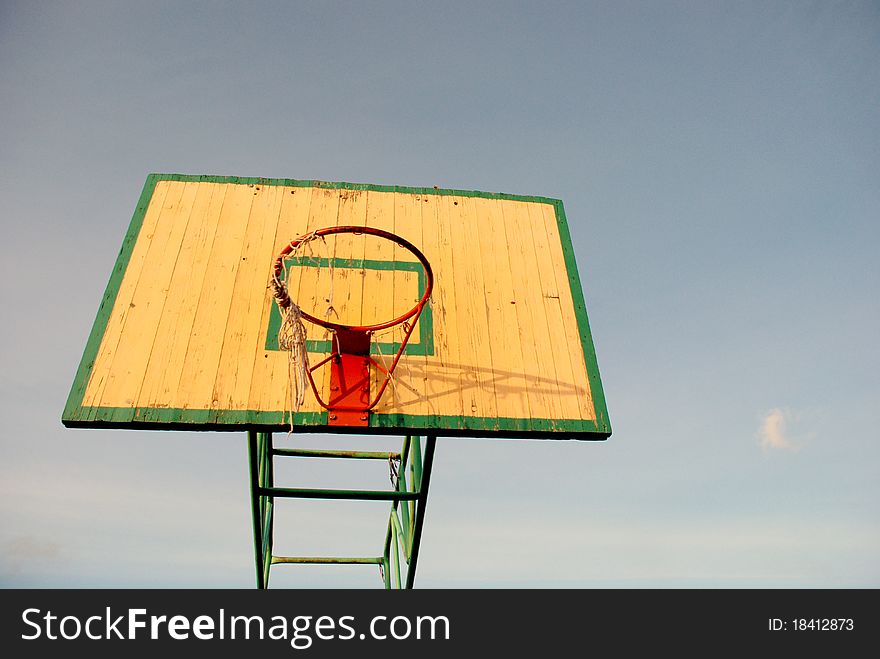 Basketball board with an old tattered basketball net on the hoop