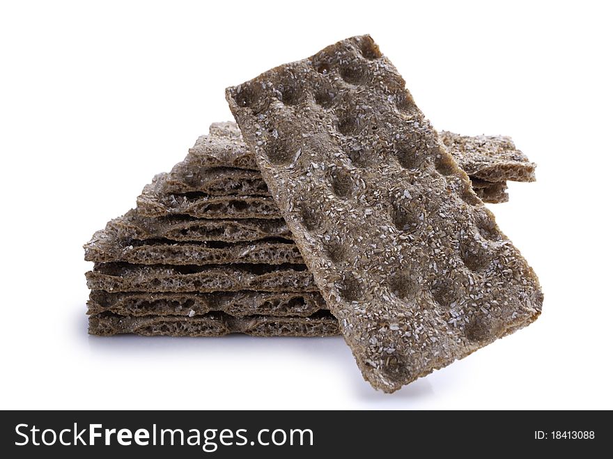 Stack of brown crisp bread with one in the front