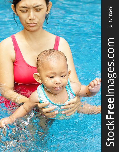 Asian ethnic mother teach baby girl to swim. Asian ethnic mother teach baby girl to swim