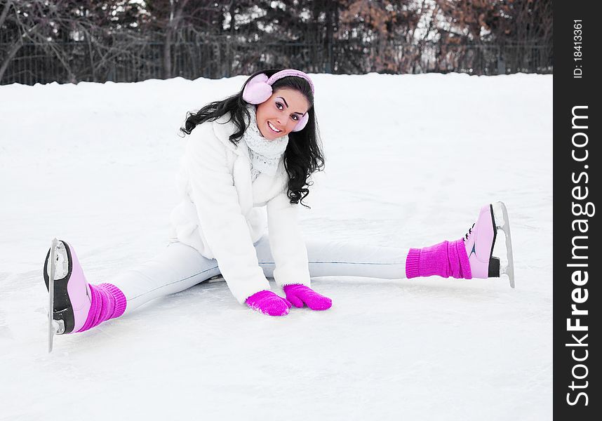 Happy beautiful girl wearing warm winter clothes ice skating. Happy beautiful girl wearing warm winter clothes ice skating