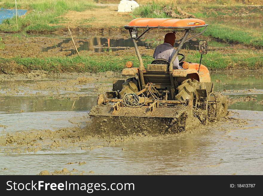 There is a famer working in the farm