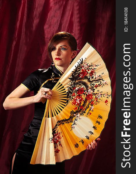 Samurai Girl in kimono with fan on red background. Samurai Girl in kimono with fan on red background